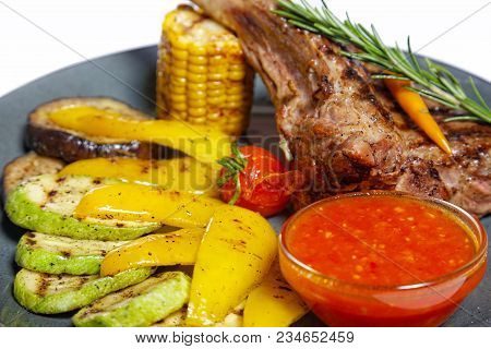 Grilled Meat On Bone With Garnish Of Vegetables