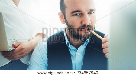 Bearded Young Businessman Working On Modern Office. Consultant Man Thinking Looking In Monitor Compu
