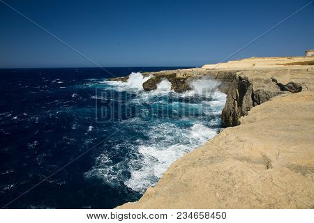 Wild Waves Of The Ocean Splash The Dry Shores Of Gozo, Malta