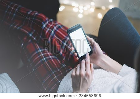 Closeup Of A Man Using A Black Smartphone With A Blank Screen In The Cozy Atmosphere Of Domani Sitti