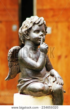 Cupid Sitting On A Stone Pedestal, Not Noise.