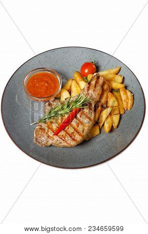 Fried Meat With Garnish Of Pepper, Zucchini, Tomato And Corn With Ajika Sauce Served On A Gray Plate