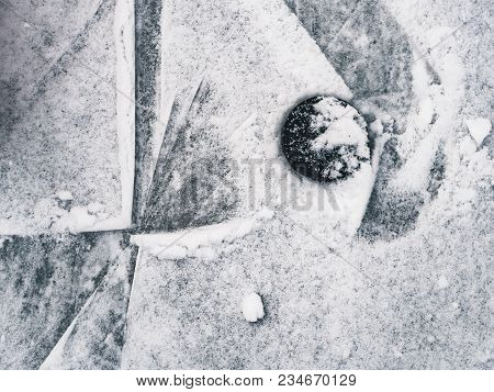 Top Down View Of Hockey Puck And Skates On Ice