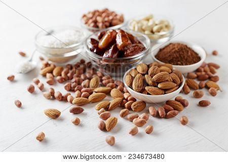 Ingredients For Chocolate Energy Bites On White Wooden Table. Heatlhy Snacks For Lunch.