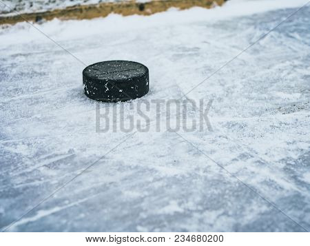 Hockey Puck On Ice With Snow Texture