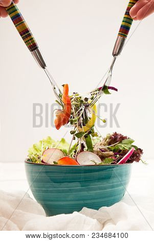 Blue Bowl With Fresh Vegetarian Salad Of Raw Vegetables And Microgreen On White Background. Two Fork