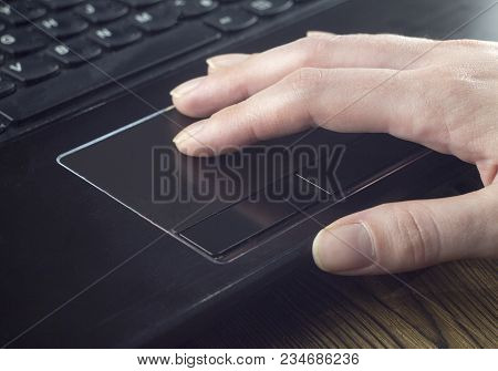 Hand On The Laptop's Touchpad