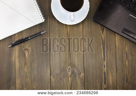Laptop, Coffee, Notepad Pen On A Wooden Table