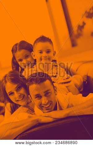 happy young family relax and have fun at modern home indooor duo tone