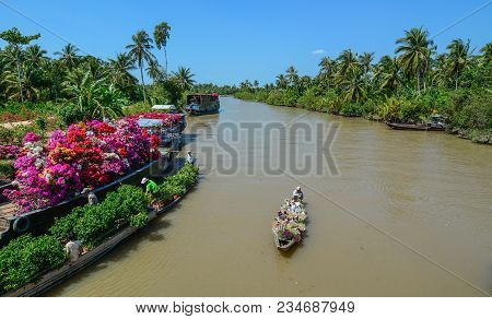 Cargo Boats Carry Flowers On River