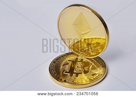 Bitcoin And Ethereum Golden Coins On A Chart Isolated On White Background, Selective Focus, Close-up