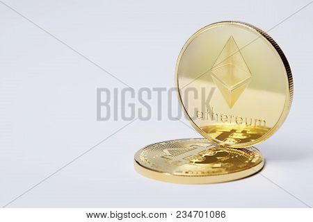 Bitcoin And Ethereum Golden Coins On A Chart Isolated On White Background, Selective Focus, Close-up