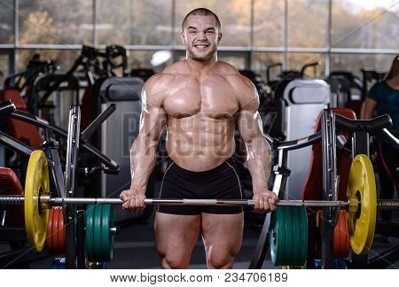 Brutal Strong Bodybuilder Athletic Men Pumping Up Muscles With Dumbbells