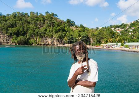 Castries, St.lucia - November 26, 2015: African Man Show Victory Or Peace Gesture On Blue Sea. Old H