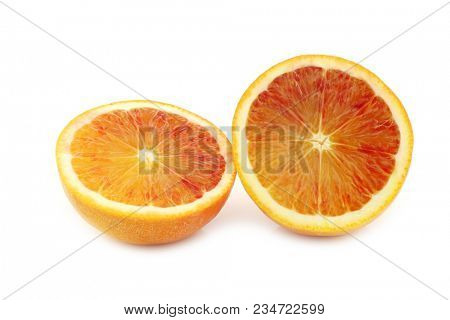 two fresh blood orange halves on a white background