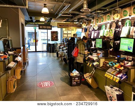 LONDON - APRIL 5, 2018: Customers pay for products at the checkout in Whole Foods Market, Piccadilly, London, UK.