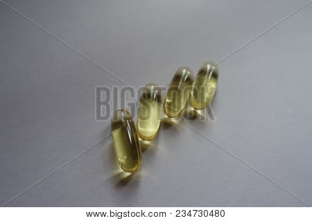 Group Of Four Yellow Fish Oil Capsules