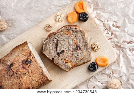 Rye Bread With Nuts, Dried Fruits, Apricots And Prunes, Dessert. The Whole Loaf And The Cut Pieces O