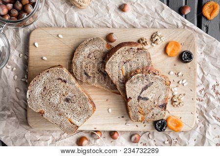 Rye Bread With Nuts, Dried Fruits, Apricots And Prunes, Dessert. The Whole Loaf And The Cut Pieces O