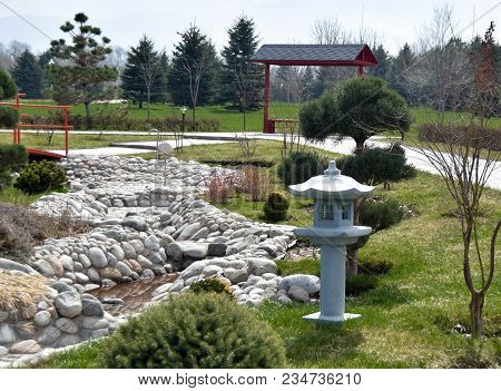 Japanese Lantern In The Garden, Stone River And Mountains