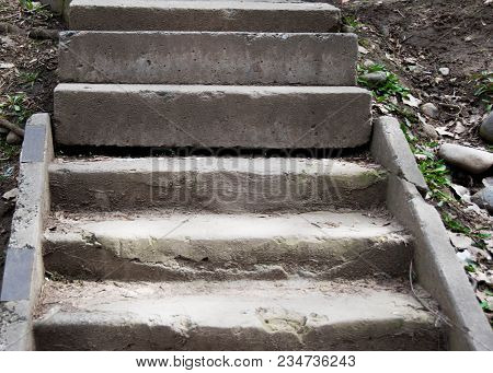An Old Open Outer Stone Staircase. Stone, Cement Steps Of The Old Staircase With Traces Of Weatherin