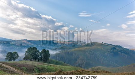 Beautiful Mountain Landscape Of A Foggy Morning With And Old House, Trees And Clouds, Dumesti, Salci