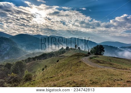 Beautiful Mountain Landscape Of A Foggy Morning With And Old House, Trees And Clouds, Dumesti, Salci