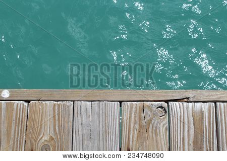 Standing On The Dock Over A Blue Ocean