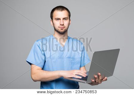 The Doctor Staring On The Laptop Isolated On Gray