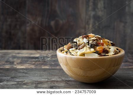 Muesli And Dried Fruit In Wooden Bowl On Wooden Table. Copspace