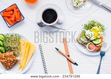 Top View Planning Notebook With Copy Space And Healthy Breakfast. Sandwich With Egg Benedict And Smo
