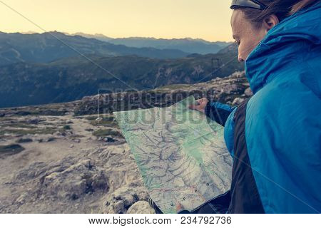Female Trekker Studying A Map. Exploring Brenta Dolomites,