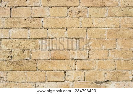 Textured Background Of A Stone Brick Of Yellow Antediluvian Masonry. Partially Destroyed Wall. Brick