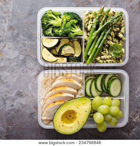 Green And Healthymeal Prep Containers With Chicken And Pasta With Green Pesto Sauce And Vegetables