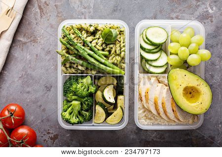 Green And Healthymeal Prep Containers With Chicken And Pasta With Green Pesto Sauce And Vegetables