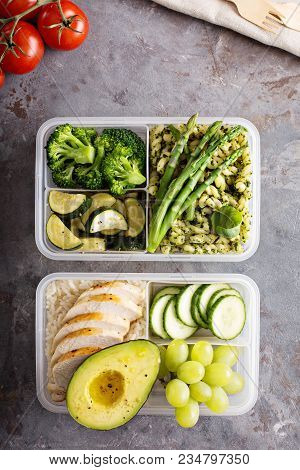 Green And Healthymeal Prep Containers With Chicken And Pasta With Green Pesto Sauce And Vegetables