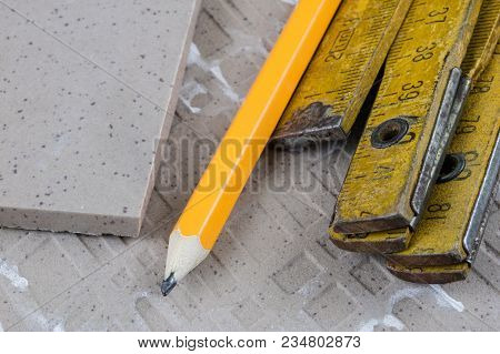 Laying And Cutting Tiles. Tools And Building Materials At A Working Position. Tiles For Industrial A