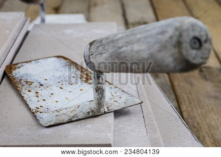 Laying And Cutting Tiles. Tools And Building Materials At A Working Position. Tiles For Industrial A