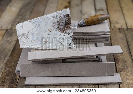 Laying And Cutting Tiles. Tools And Building Materials At A Working Position. Tiles For Industrial A