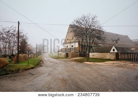 Farm House On A Foggy Winter Day. Market Town Of Guntersdorf In The District Of Hollabrunn, Lower Au