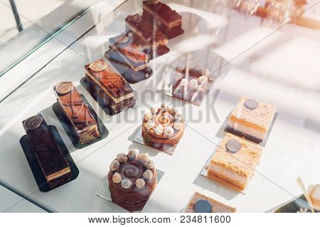Assortment Of Colorful Macaroons On Cafe Showcase. Variety Of Macaron Flavours. Sweet Almond Cakes I