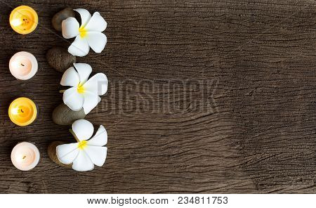 Spa Concept Background With Stone ,frangipani Or Plumeria  And Burning Candles On Wood With Copy Spa