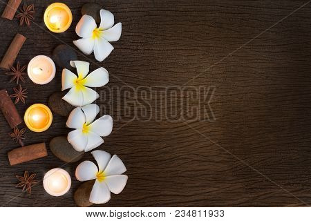 Spa Concept Background With Stone ,frangipani Or Plumeria  And Burning Candles On Wood With Copy Spa
