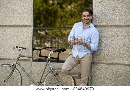 Young Happy Attractive Hispanic Man In Casual Trendy Clothes Smiling Cheerful Using Mobile Phone On 