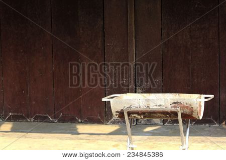 Steel Cylinders Placed In Front Of An Old Wooden Wall.