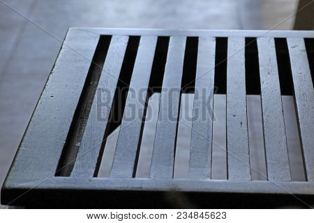 The Seat Of The Brown Wooden Chair Is A Groove.