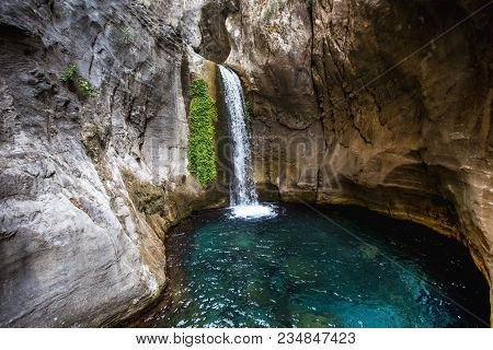 Travel And Sighseeing Concept. Beautiful Waterfall And Natural Pool With Pristine Turquoise Water In