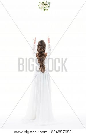 Back View Of Bride In White Dress Throwing Wedding Bouquet, Isolated On White