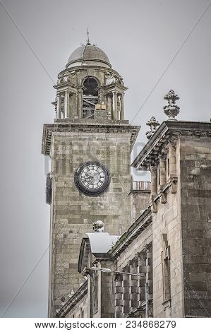 A View Of The Town Hall Clock Tower In Clydebank Through A Nearby Archway.