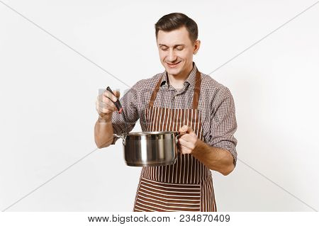 Man Chef In Striped Brown Apron Holding Silver Stainless Glossy Aluminium Empty Stewpan, Pan Or Pot,